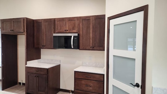 kitchen featuring dark brown cabinets