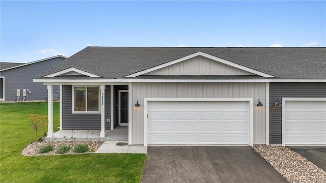 ranch-style house with a front yard and a garage