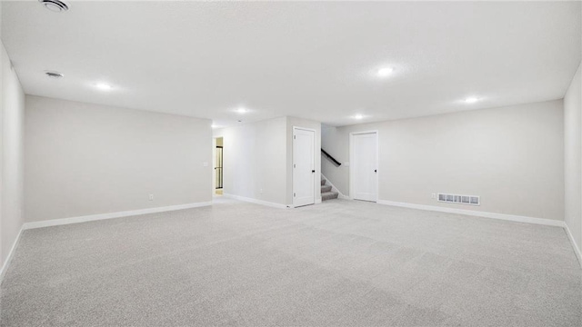 basement featuring light colored carpet