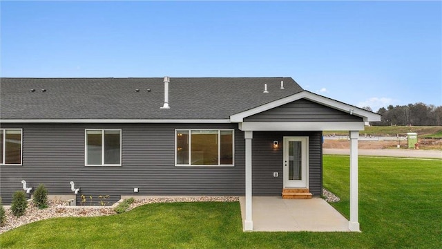 back of house with a yard and a patio