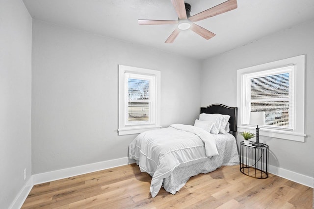 bedroom with ceiling fan and light hardwood / wood-style floors