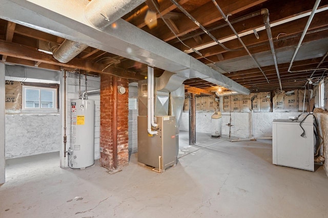 basement featuring washer / dryer, heating unit, and gas water heater