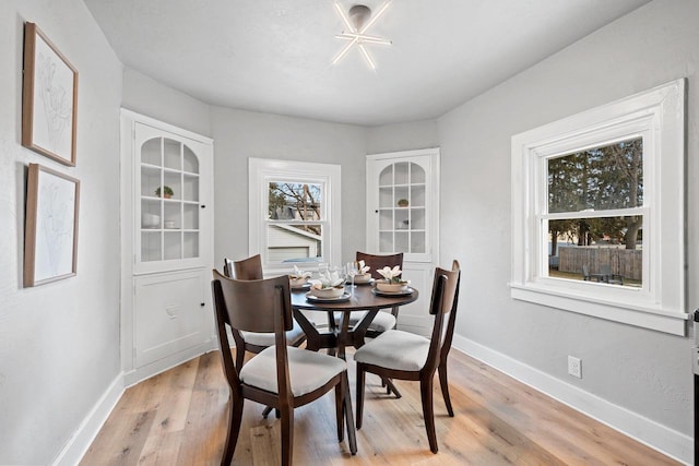 dining space with light wood-type flooring