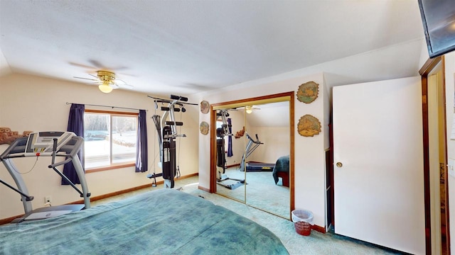 bedroom with lofted ceiling, ceiling fan, a closet, and carpet