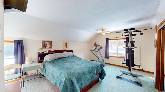 bedroom featuring ceiling fan, vaulted ceiling, and light carpet