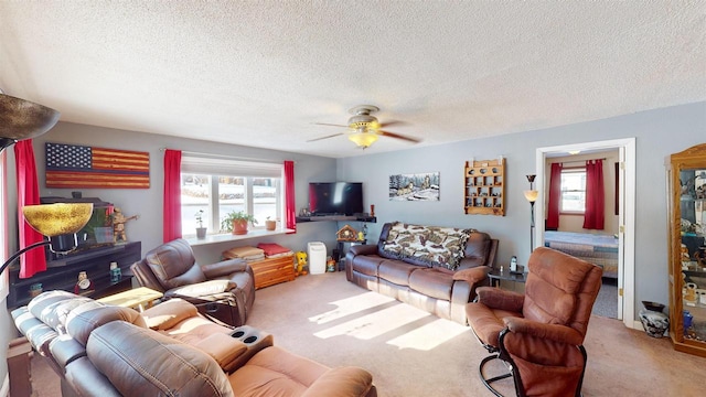 carpeted living room with ceiling fan and a textured ceiling