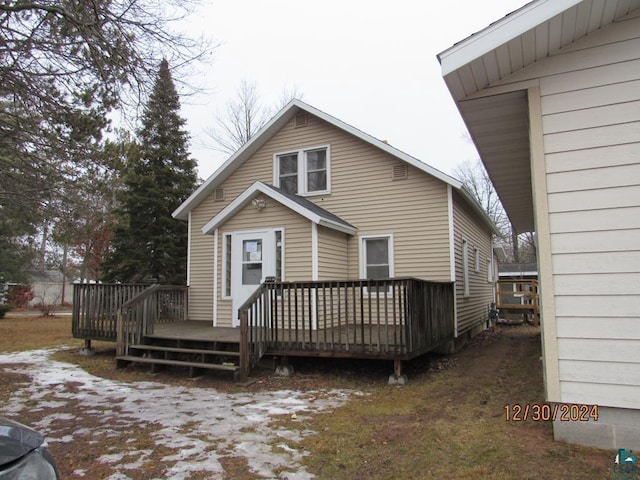 rear view of house featuring a deck