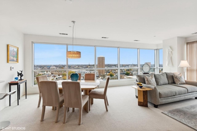 dining space featuring light carpet