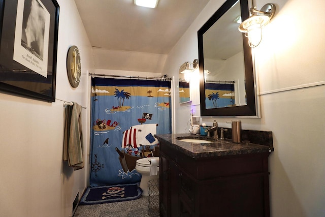 bathroom with toilet, vanity, and a shower with curtain