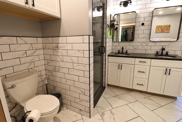 bathroom with tile walls, toilet, walk in shower, and vanity