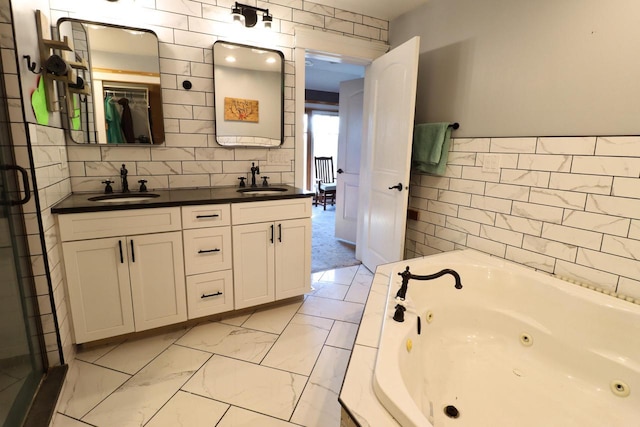 bathroom with vanity, tile walls, and a bathing tub