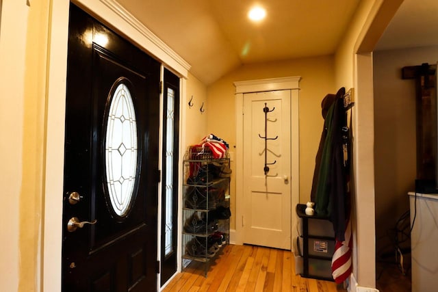 foyer featuring light hardwood / wood-style flooring and lofted ceiling