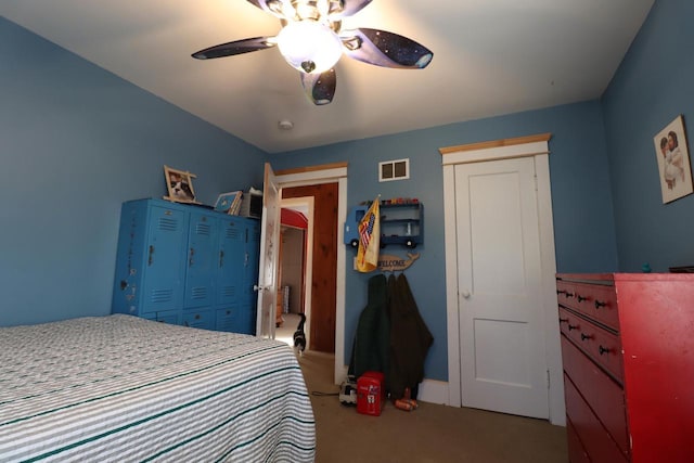 carpeted bedroom with a closet and ceiling fan