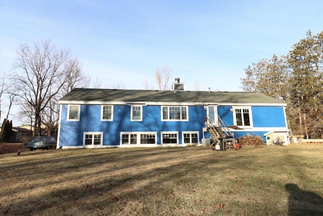 rear view of house with a yard