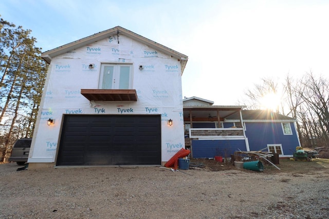 rear view of house with a garage