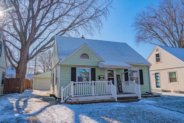 view of front facade with a garage and an outbuilding