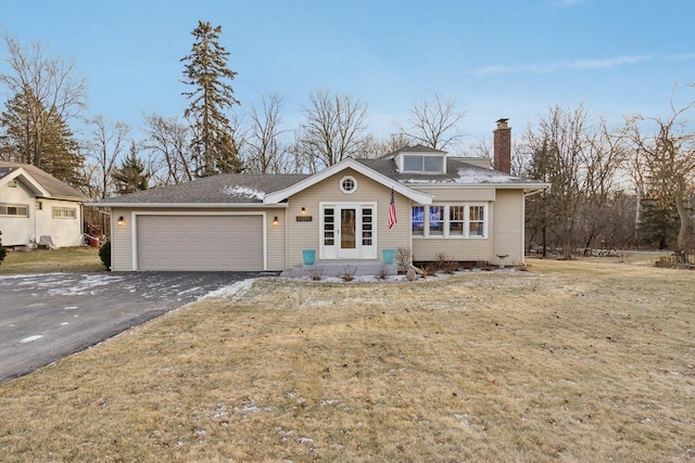 view of front of property featuring a front lawn and a garage