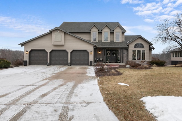 view of front of property featuring a garage and a front lawn