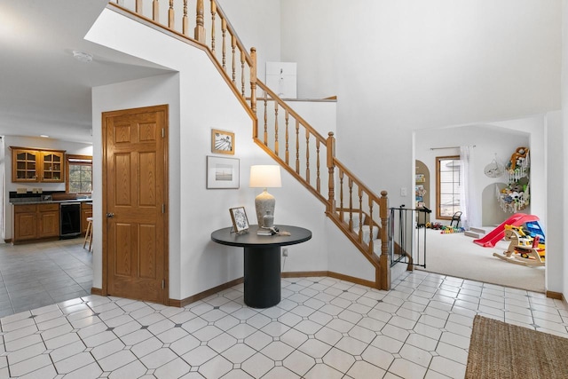 entrance foyer with wine cooler and light colored carpet