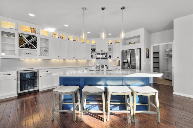 kitchen featuring stainless steel fridge with ice dispenser, white cabinetry, a center island with sink, and wine cooler