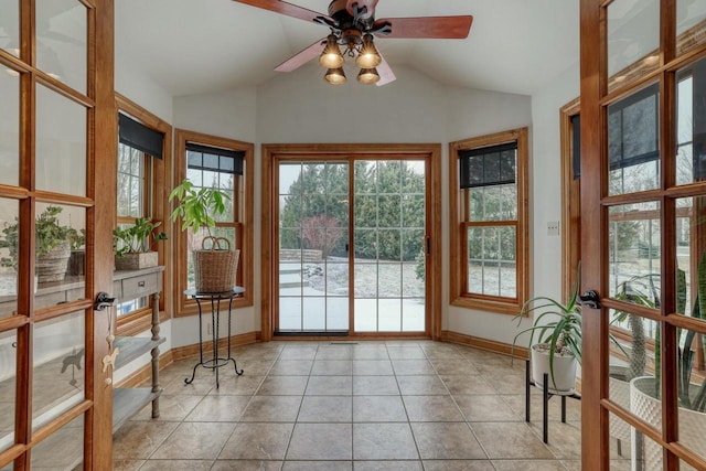 unfurnished sunroom featuring vaulted ceiling, ceiling fan, and french doors