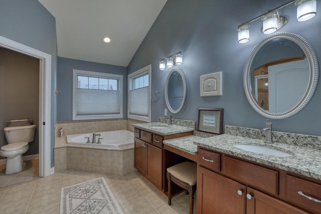 bathroom with lofted ceiling, a relaxing tiled tub, vanity, tile patterned floors, and toilet