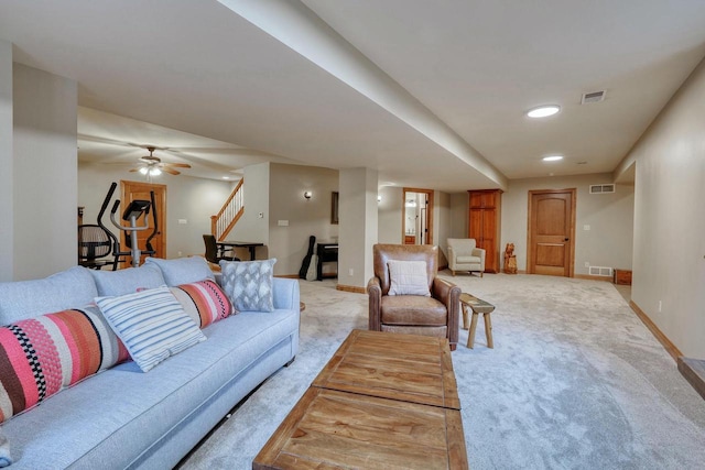 living room featuring light colored carpet and ceiling fan