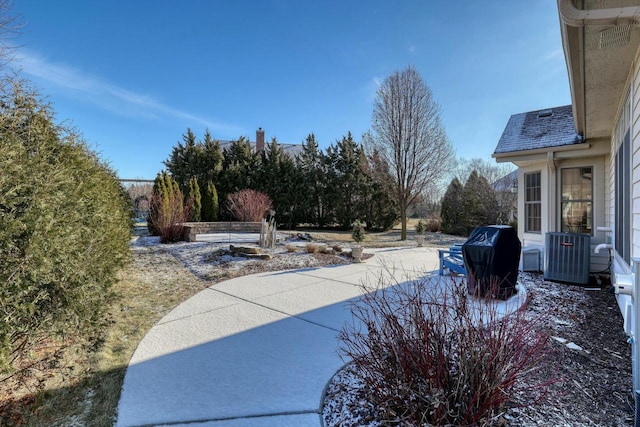 view of yard featuring cooling unit and a patio