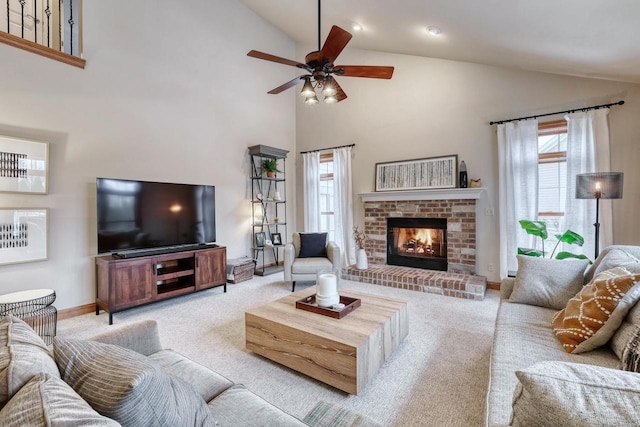 living room featuring ceiling fan, light colored carpet, plenty of natural light, and a fireplace