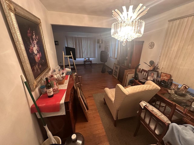 dining space with a notable chandelier and dark hardwood / wood-style flooring