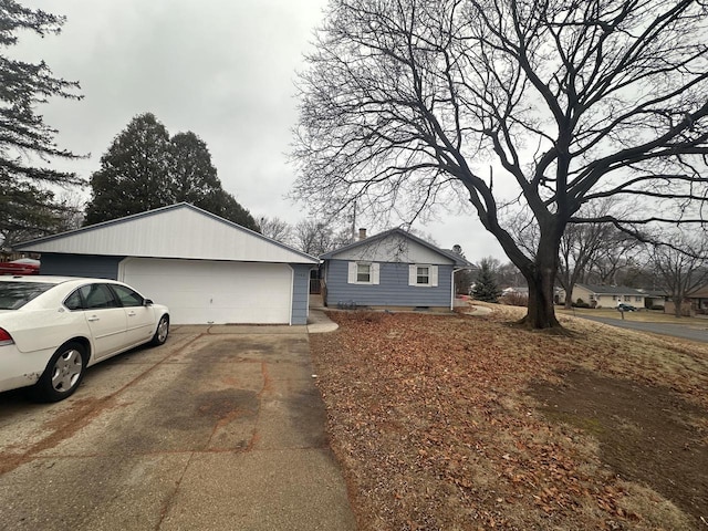 view of front of home with a garage and an outbuilding