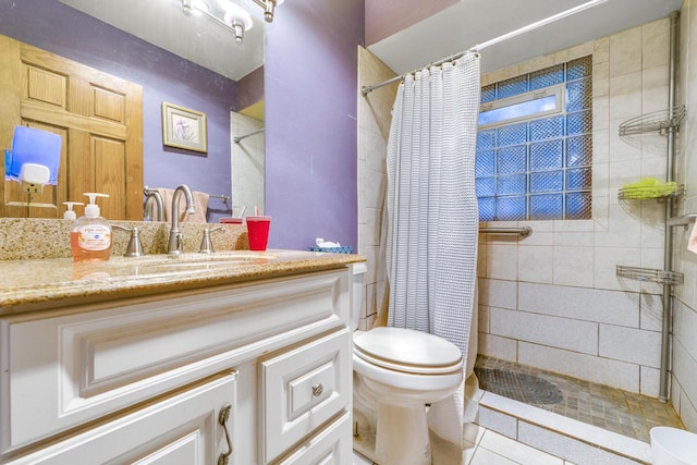 bathroom featuring vanity, tile patterned floors, toilet, and walk in shower