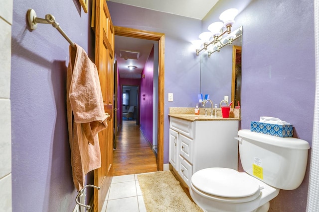 bathroom with tile patterned flooring, vanity, and toilet