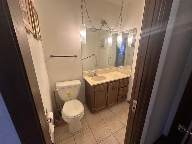 bathroom with tile patterned flooring, vanity, and toilet