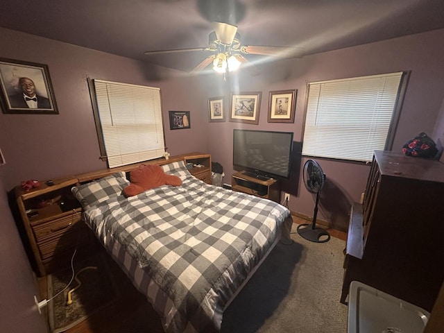 bedroom featuring ceiling fan and carpet