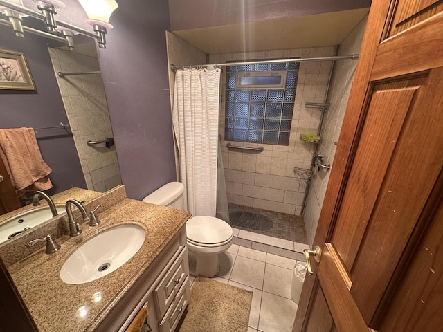 bathroom with vanity, tile patterned flooring, curtained shower, and toilet