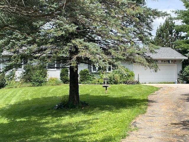 exterior space with a garage and a yard