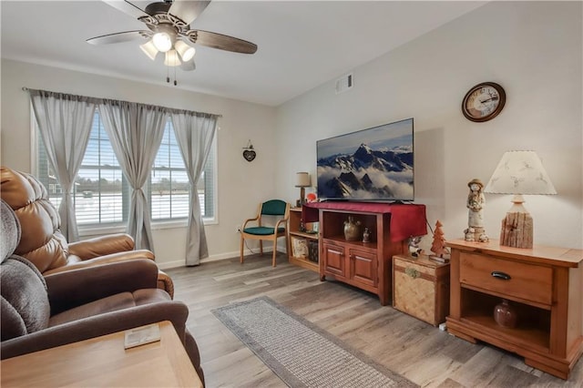 living room with ceiling fan and light hardwood / wood-style flooring