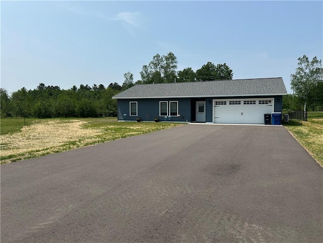 10004 Aspen Ln, Hayward, WI 54843 - ranch-style house with an attached garage, asphalt driveway, and a front lawn