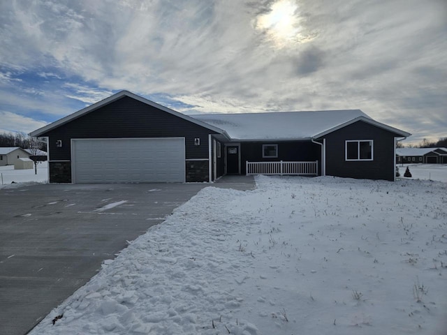 ranch-style home with a garage and covered porch