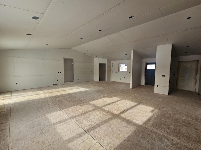 spare room with lofted ceiling