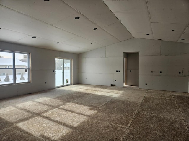 unfurnished room with vaulted ceiling