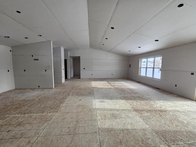 unfurnished room with lofted ceiling