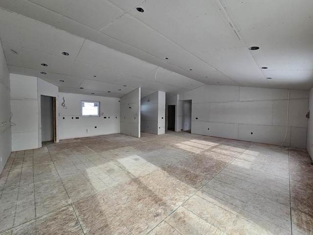 empty room featuring lofted ceiling