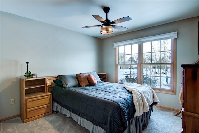 bedroom featuring ceiling fan and light carpet