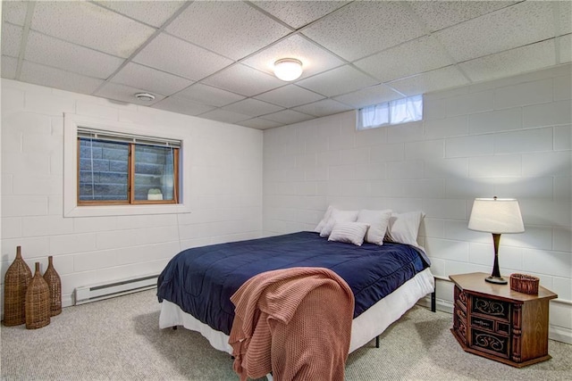 bedroom with a paneled ceiling and a baseboard radiator