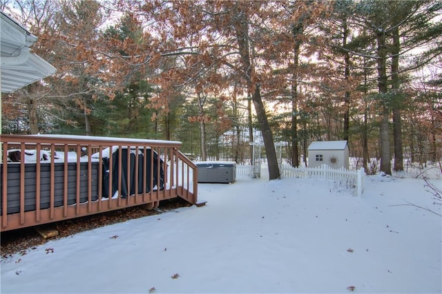 snow covered deck featuring a hot tub