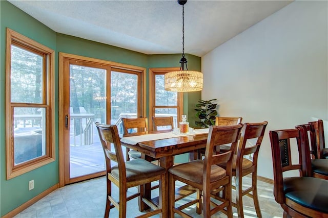 dining area featuring a notable chandelier