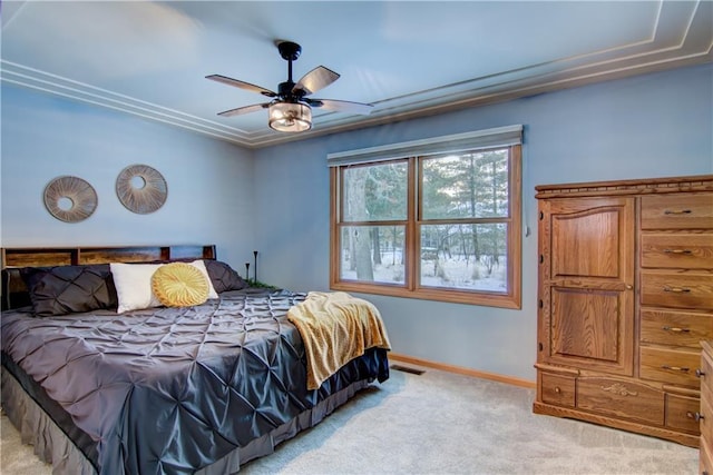 bedroom featuring ornamental molding, light colored carpet, and ceiling fan