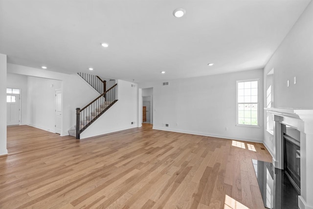 unfurnished living room featuring light hardwood / wood-style flooring